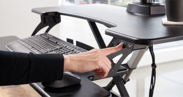 close up view of an individual pressing the keypad on an electric converter